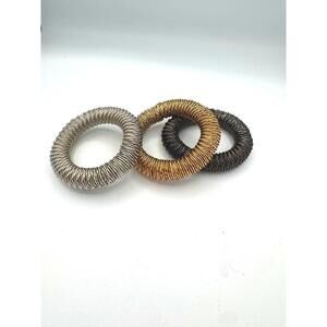 Bebe Steampunk Chunky Coil Stretch Bangles: Gold, Silver and Black Tones.